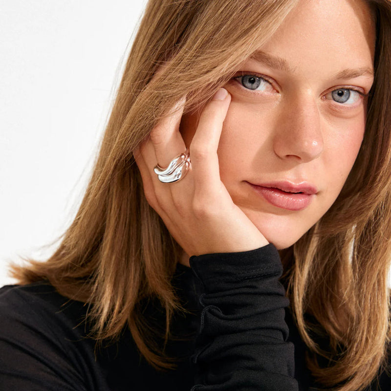 Women with natural gold huggie style earrings